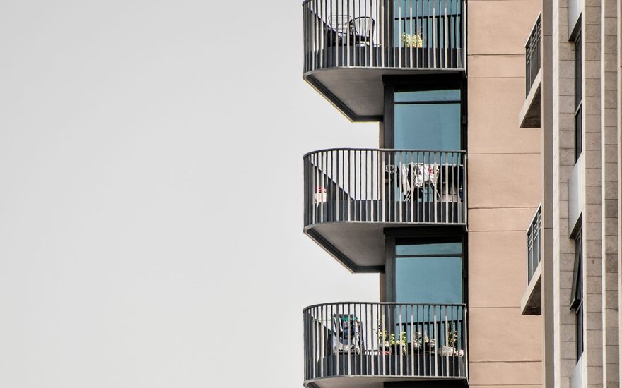 Rows of apartment balconies on a tall residential building