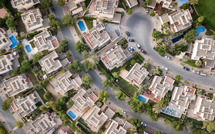 Aerial view of a villa community with private pools