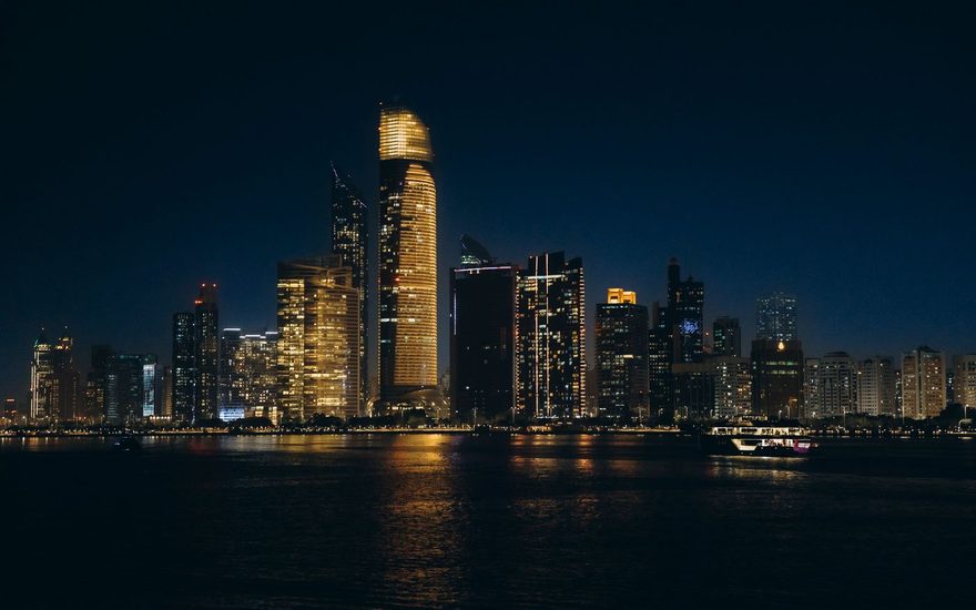 Night view of Abu Dhabi high rises from the water